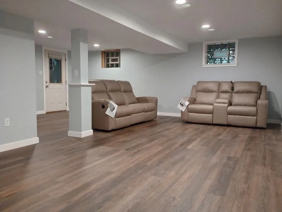 Finished basement with LVP flooring, recessed lighting, fresh drywall and paint