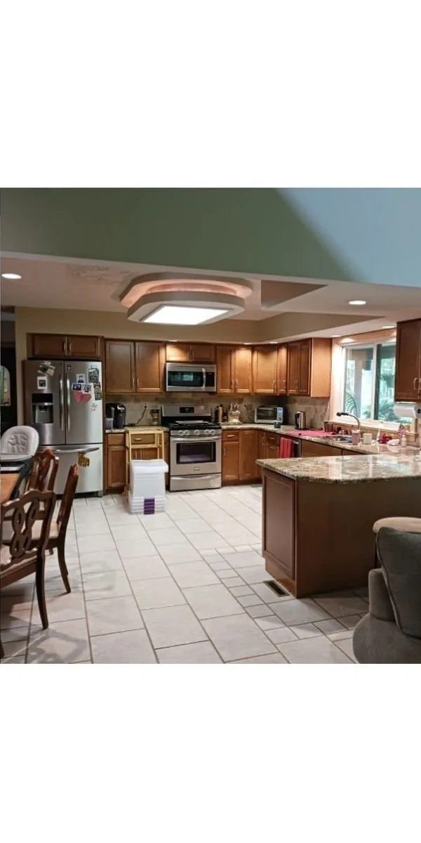 Kitchen before remodel — oak cabinets, tile floor